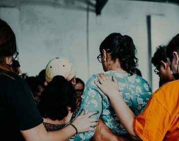 People embracing and offering compassionate support to one another